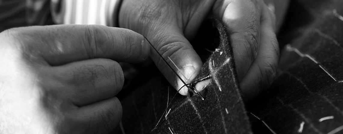 After the fit has been perfected the finishing touches are applied to the bespoke garments prior to pressing.
